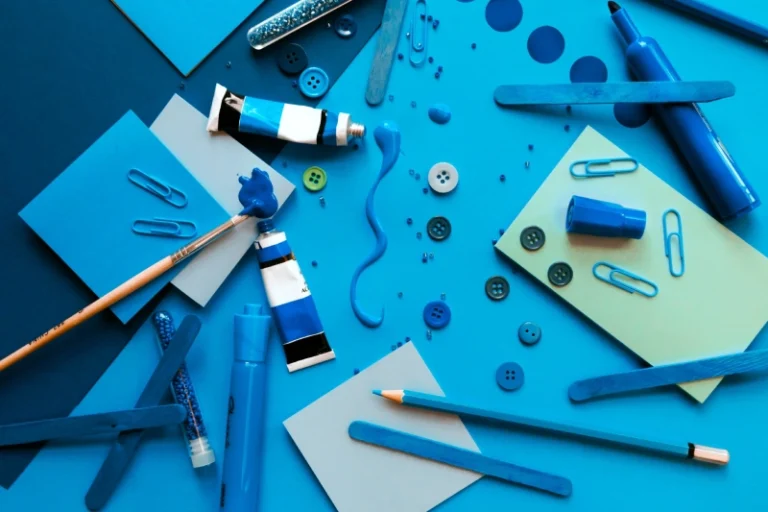 All blue art supplies including paint, post its, colored pencils, paper, and markers. How to manifest creativity.