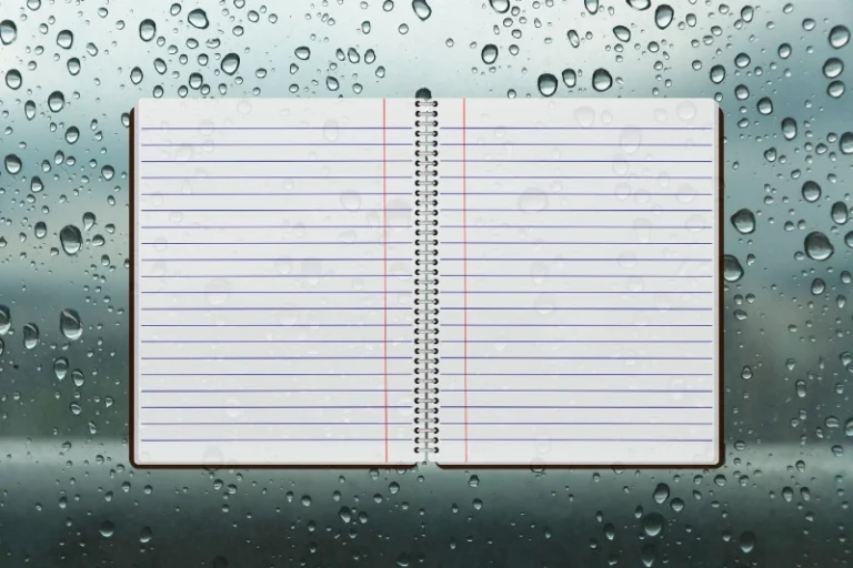 An open notebook on a rainy background with drops. What is a pray rain journal.