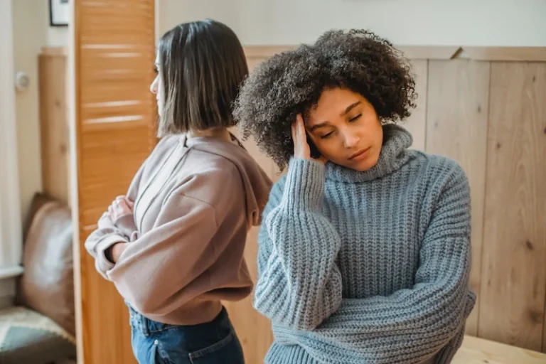 Two friends looking away from each other upset after an argument. Recovering from a toxic friendship.