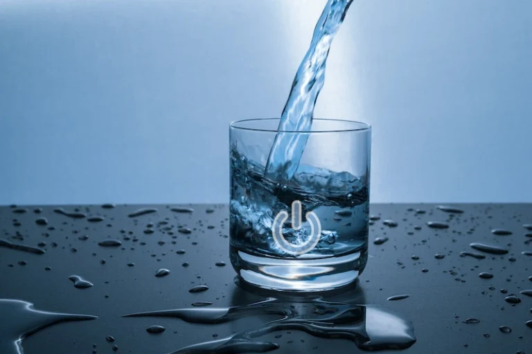 A stream of water pouring into a clear glass with a power symbol on it. How to manifest with water.